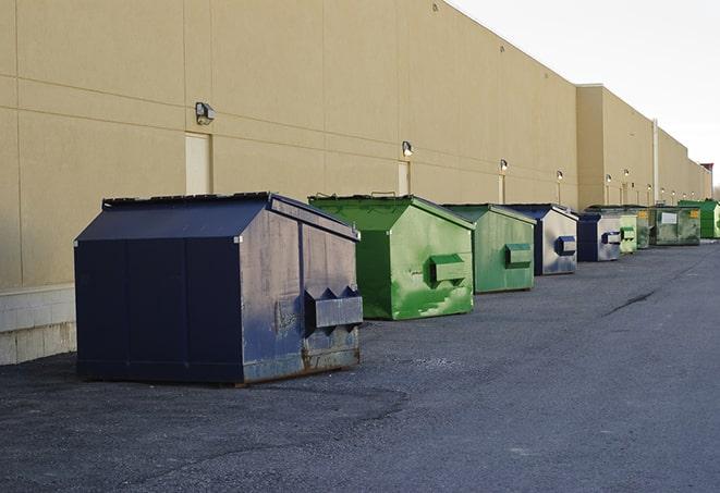 metal waste containers sit at a busy construction site in Assonet